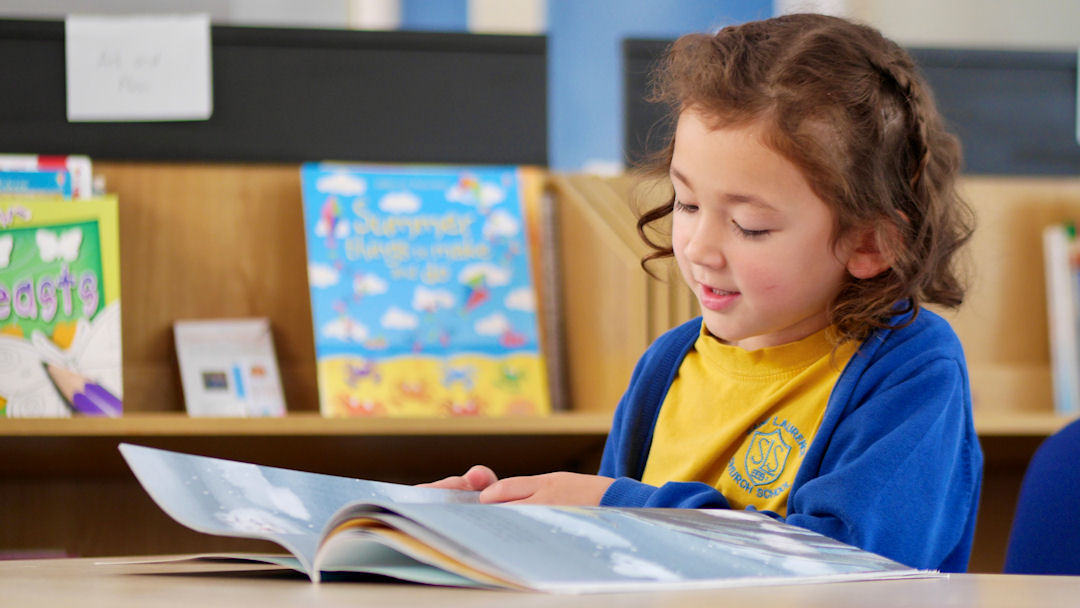 A young girl reading a book
