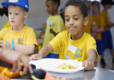 Young boy being served his school lunch