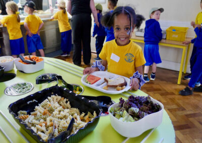A school girl helping herself at the salad bar