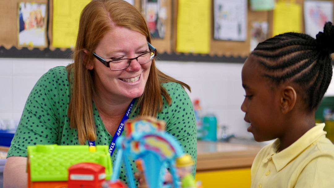 A staff member working with a young girl